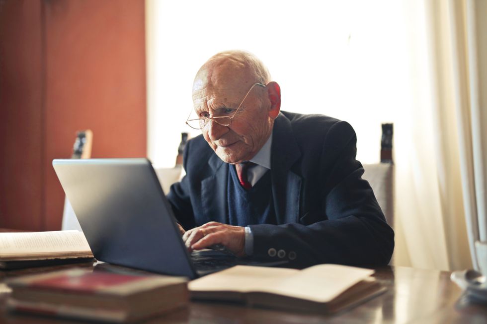 Pensioner looks at laptop