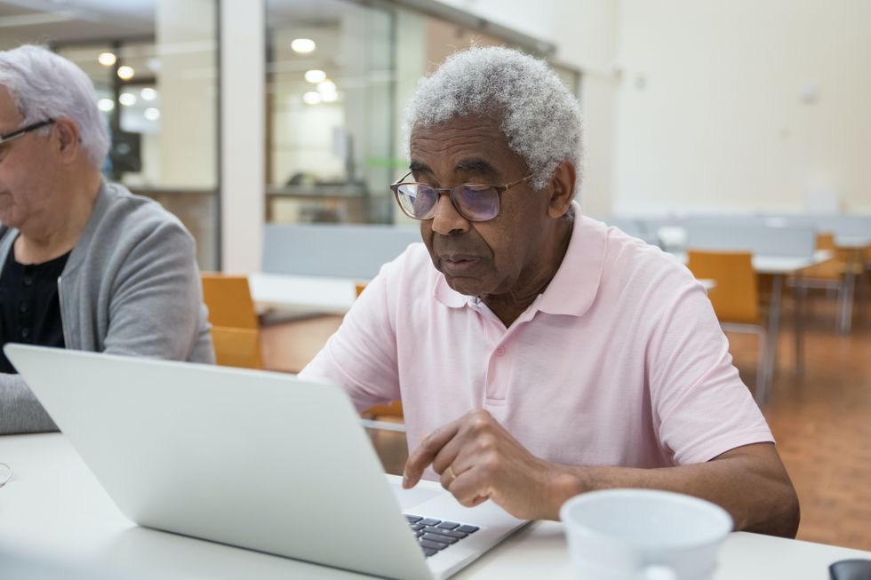 Pensioner looks at laptop