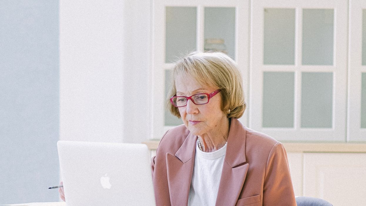 Pensioner looks at laptop
