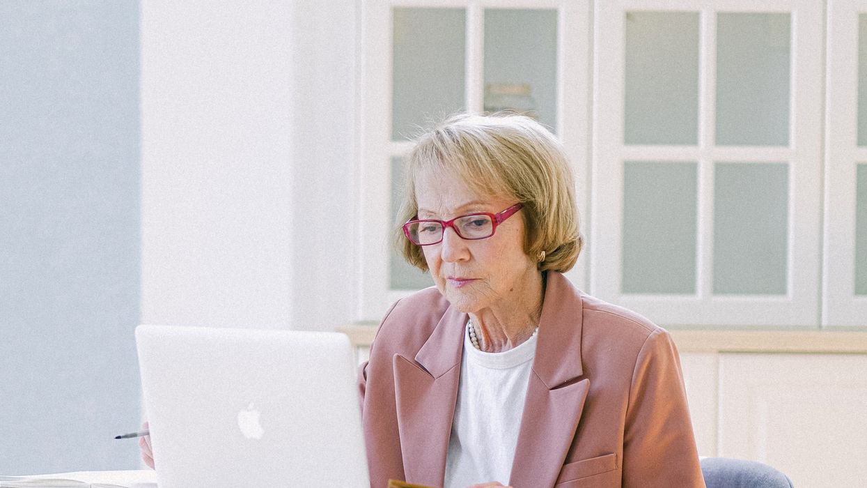 Pensioner looks at laptop