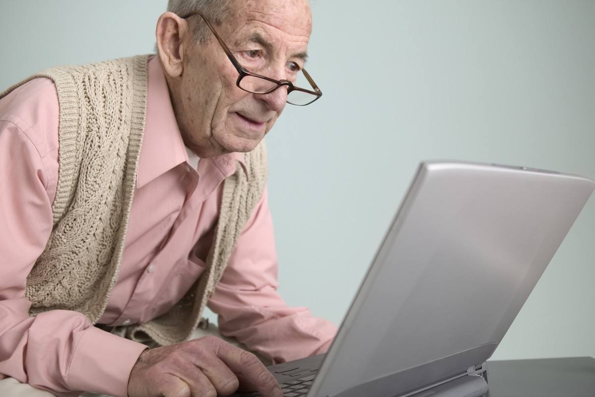 Pensioner looks at laptop