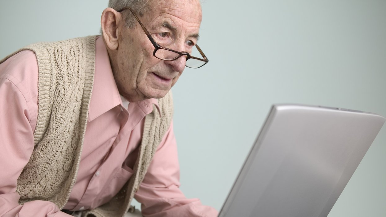 Pensioner looks at laptop
