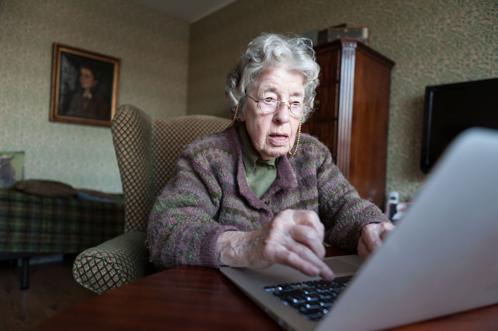 Pensioner looks at laptop