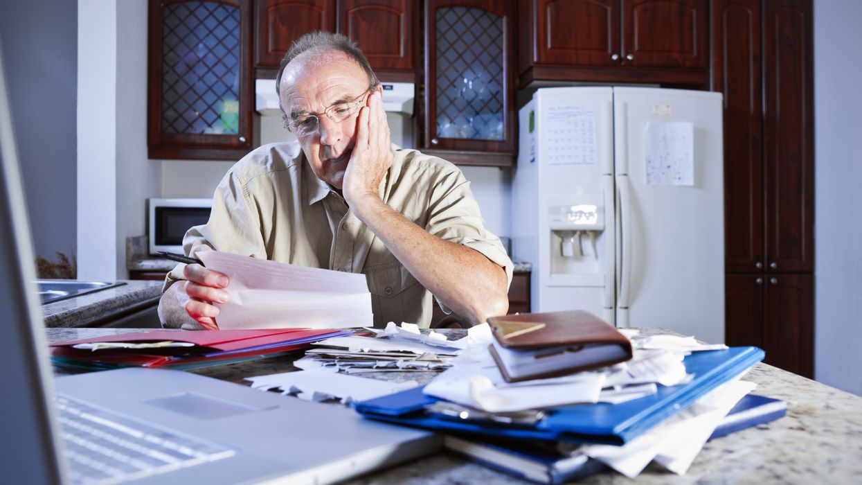 Pensioner looks at letter looking worried