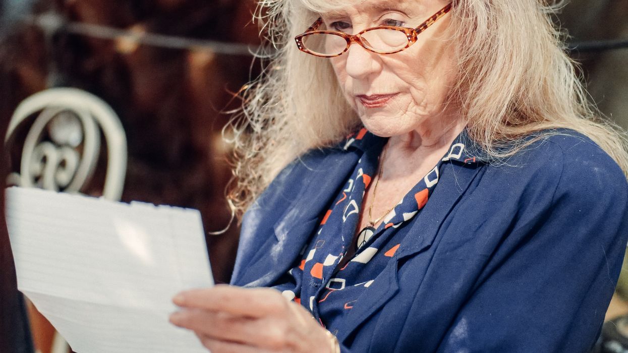Pensioner looks at letter