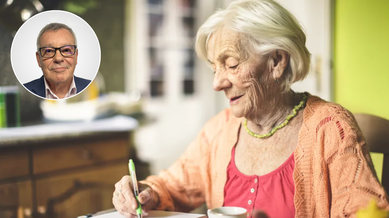 Pensioner looks at notepad and Nigel Nelson