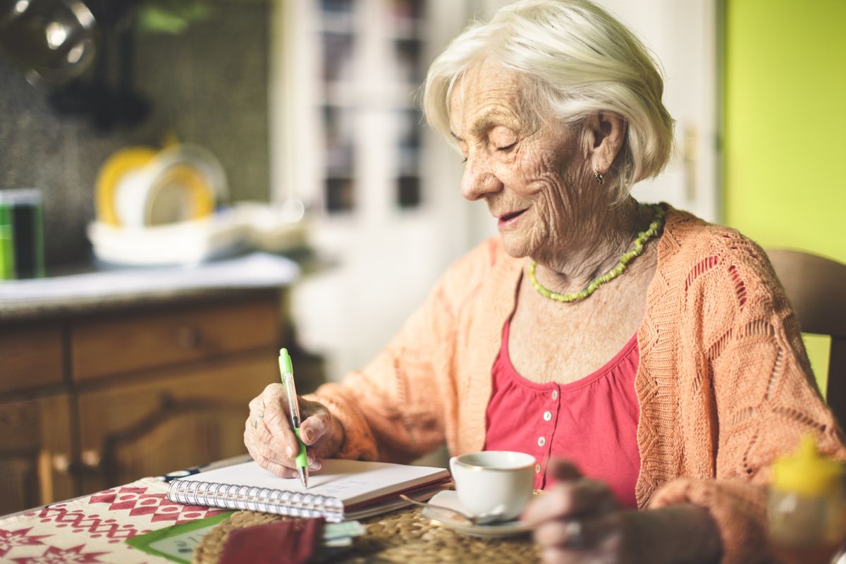 Pensioner looks at notepad