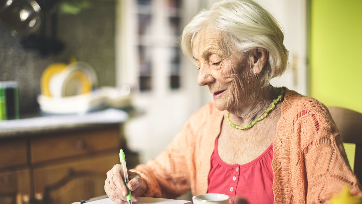 Pensioner looks at notepad