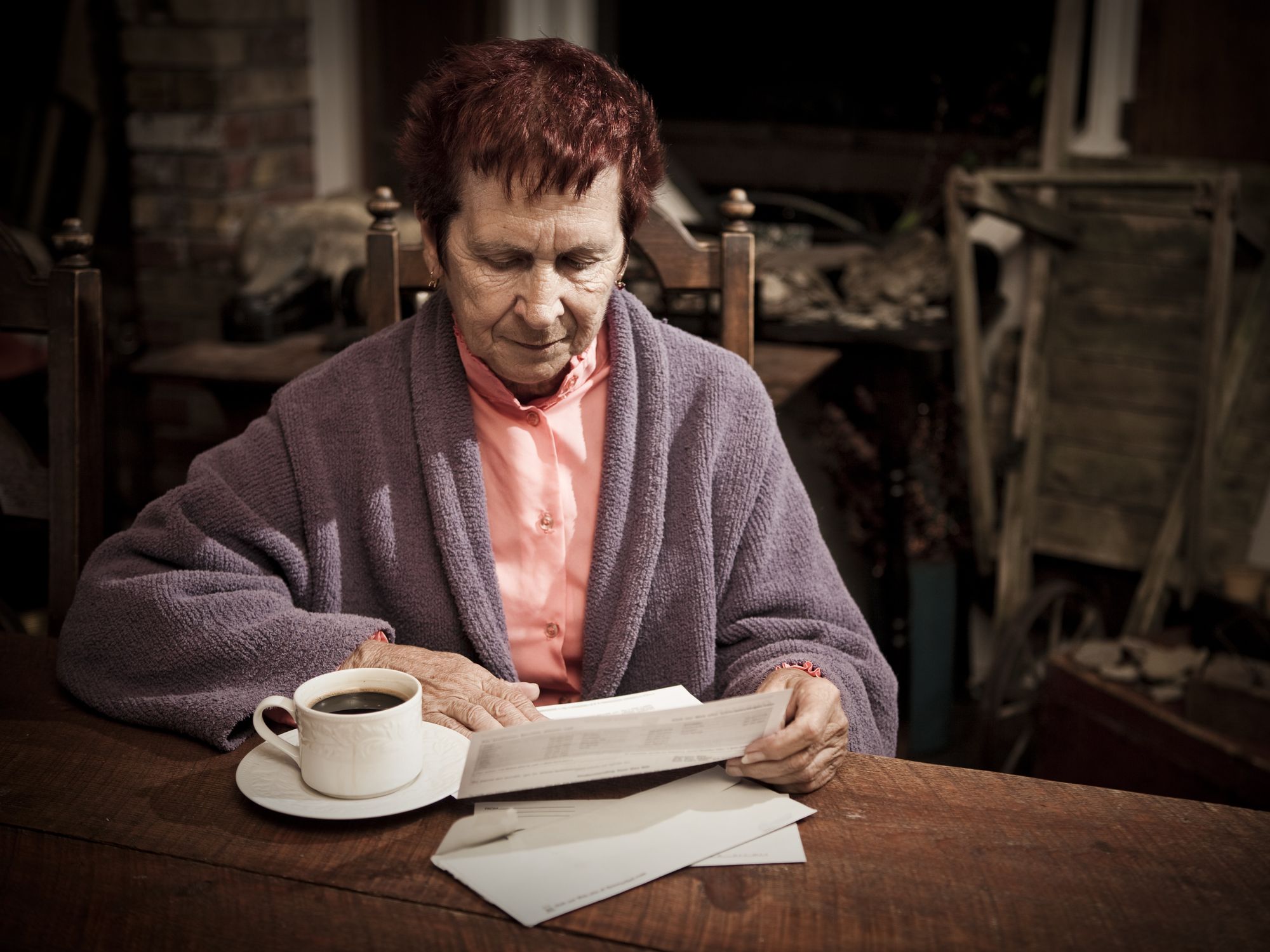 Pensioner looks worried at bills