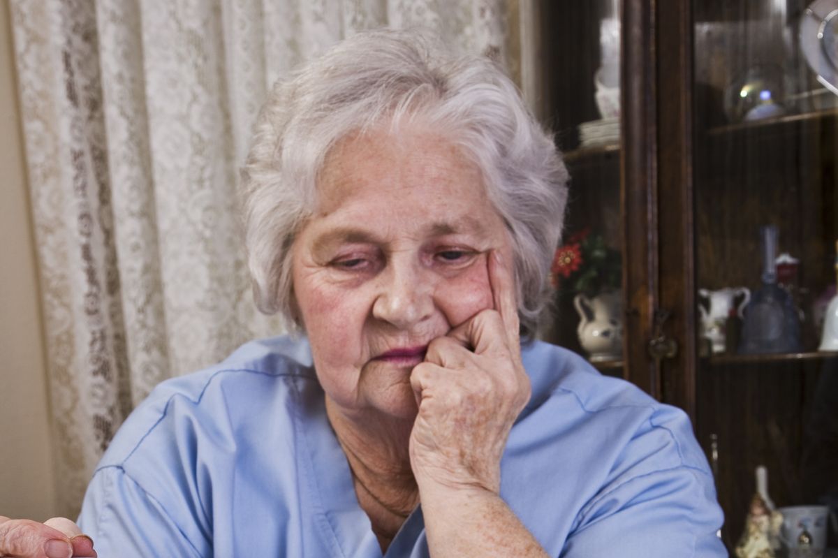 Pensioner looks worried at energy bill final notice