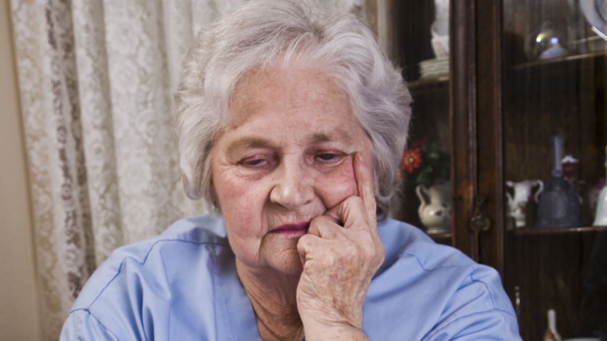Pensioner looks worried at energy bill final notice