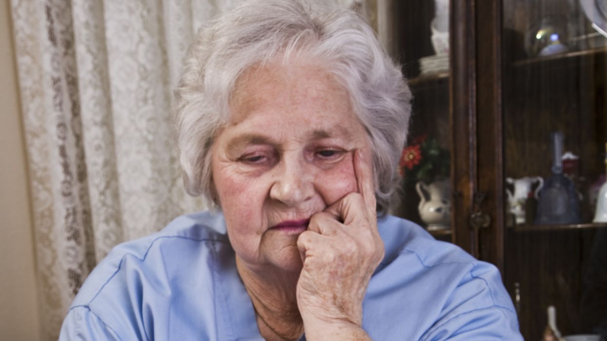 Pensioner looks worried at energy bill final notice
