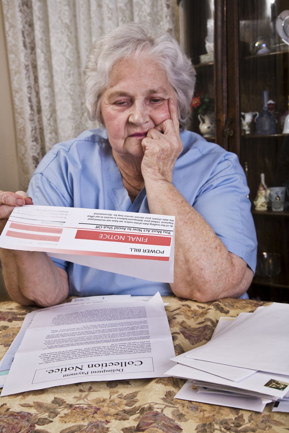 Pensioner looks worried at energy bill final notice