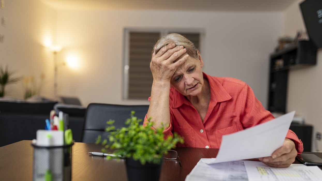 Pensioner looks worried at tax statement