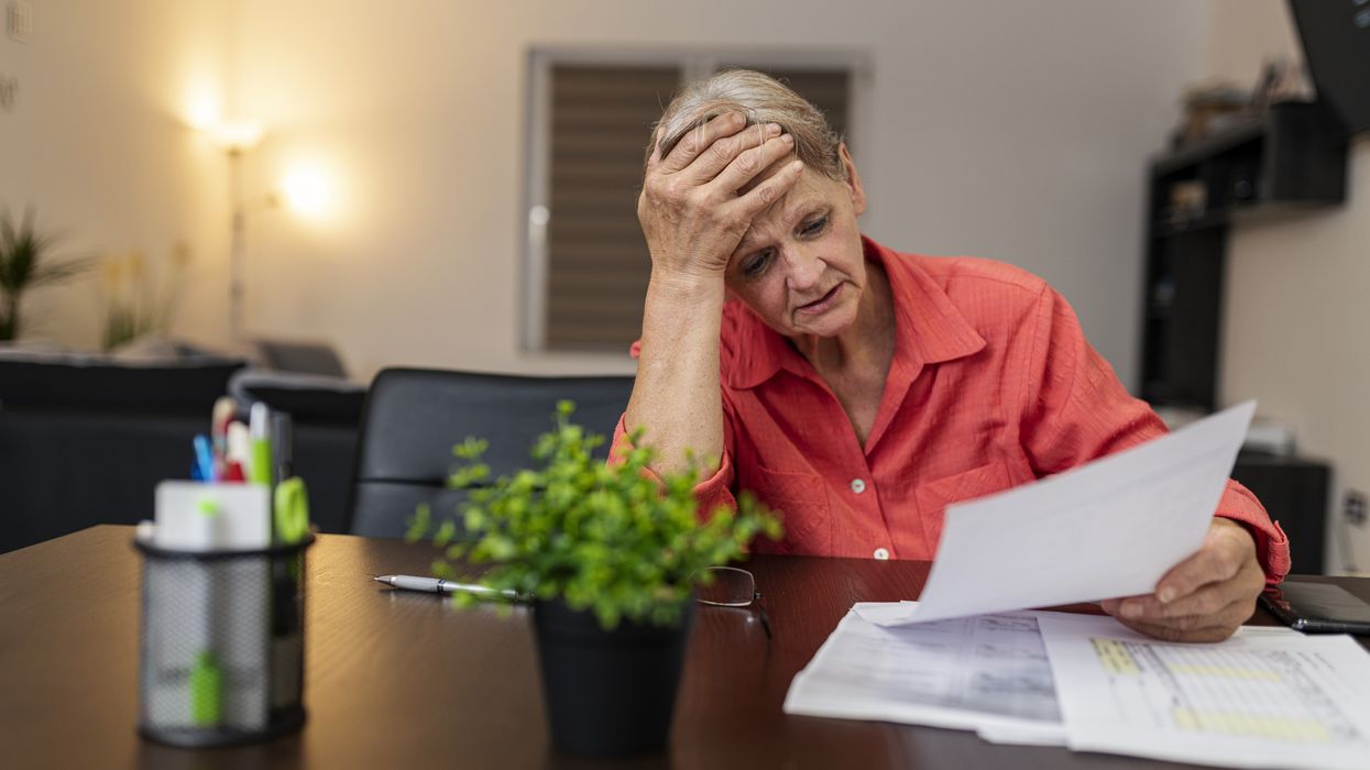 Pensioner looks worried at tax statement