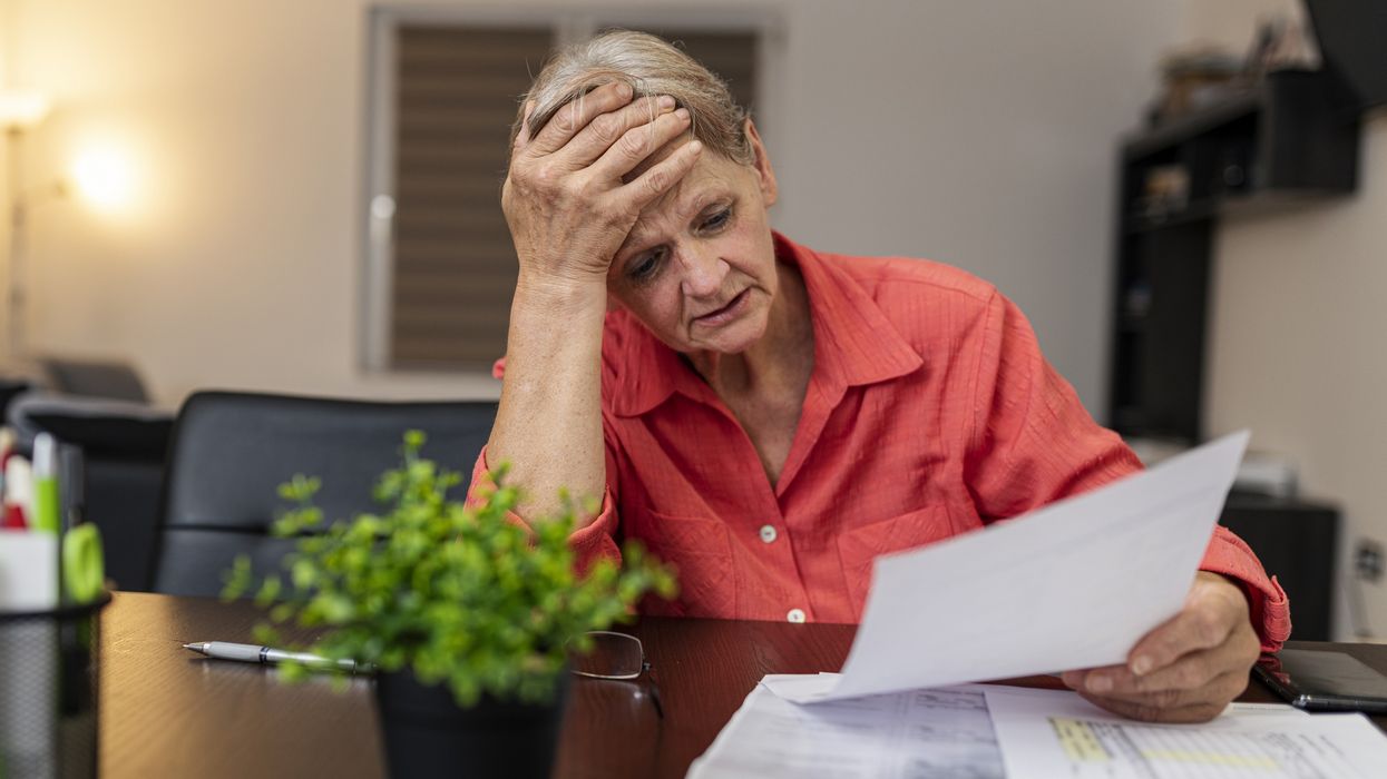 Pensioner looks worried at tax statement