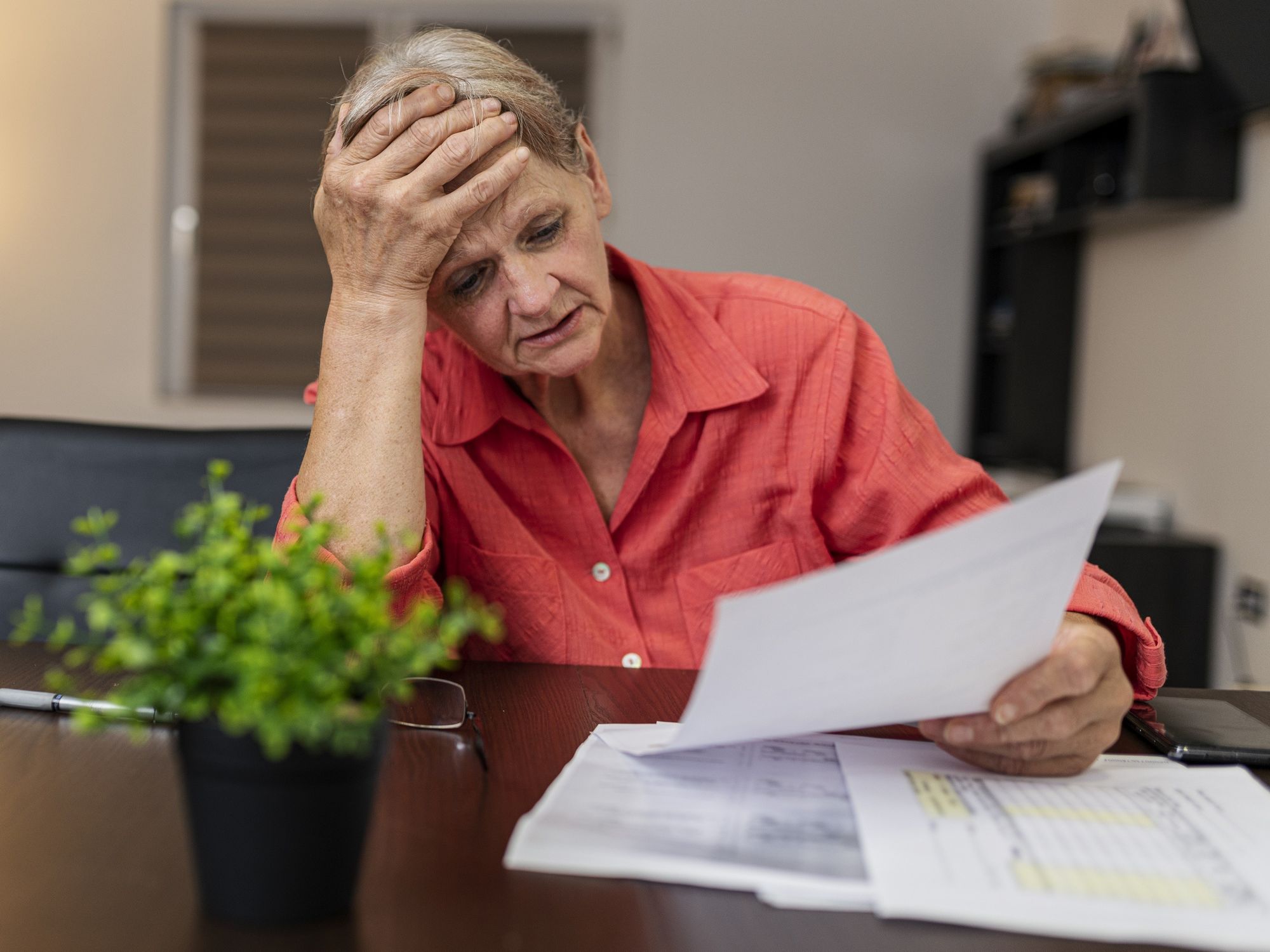 Pensioner looks worried at tax statement