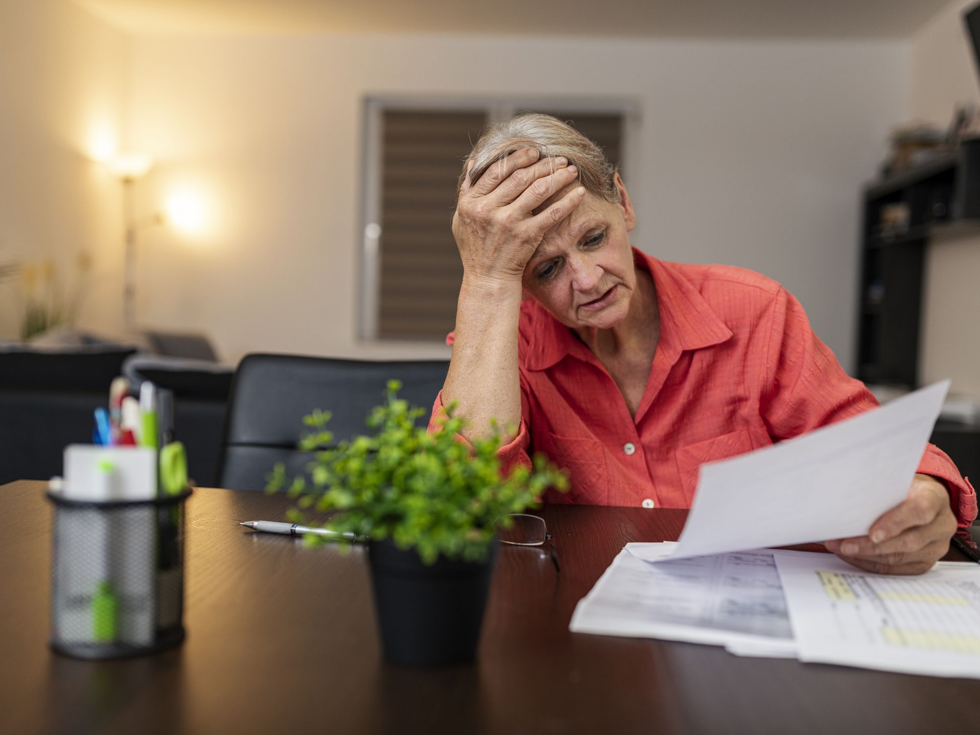 Pensioner looks worried at tax statement