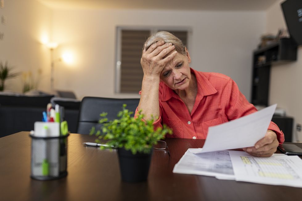 Pensioner looks worried at tax statement