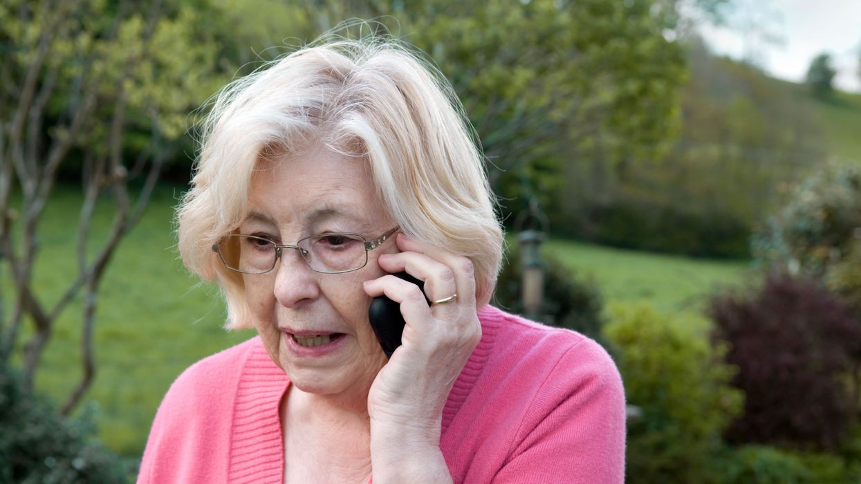 Pensioner on the phone outside