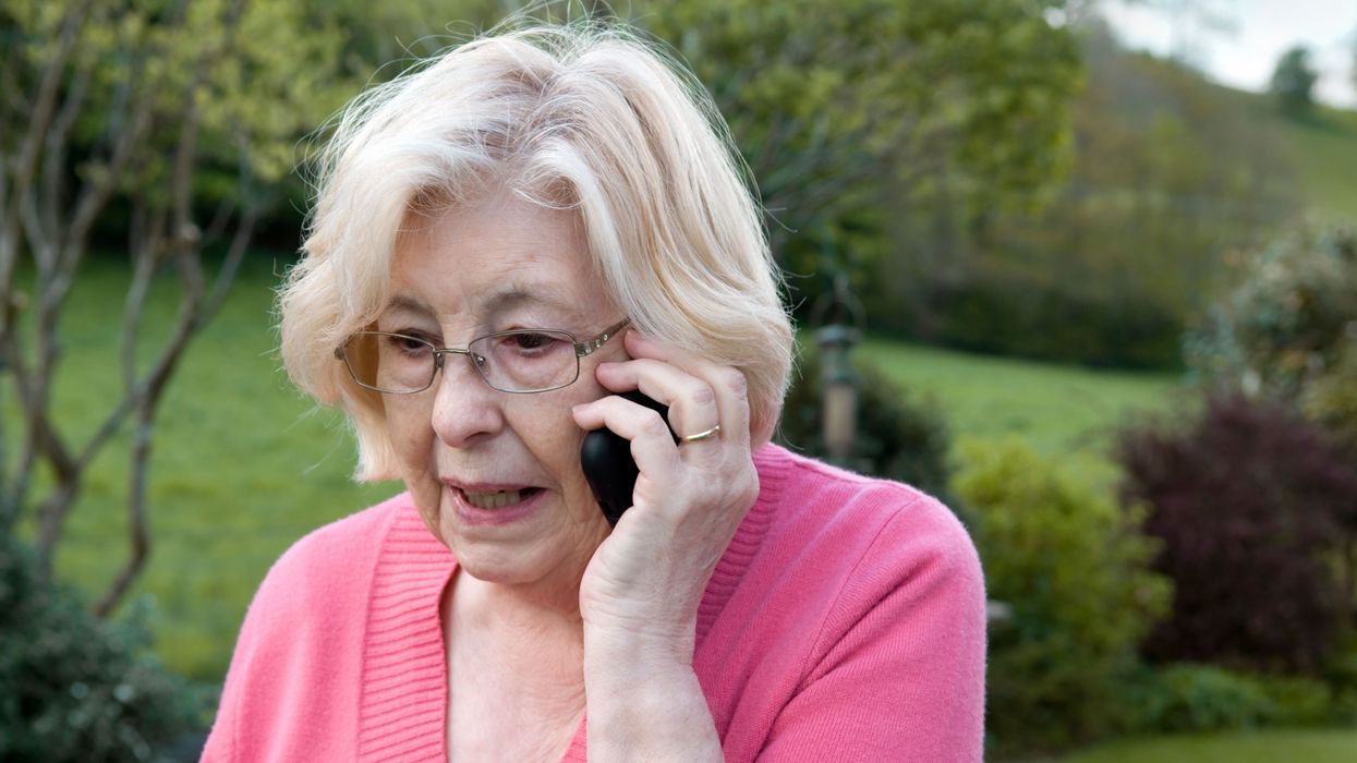 Pensioner on the phone outside