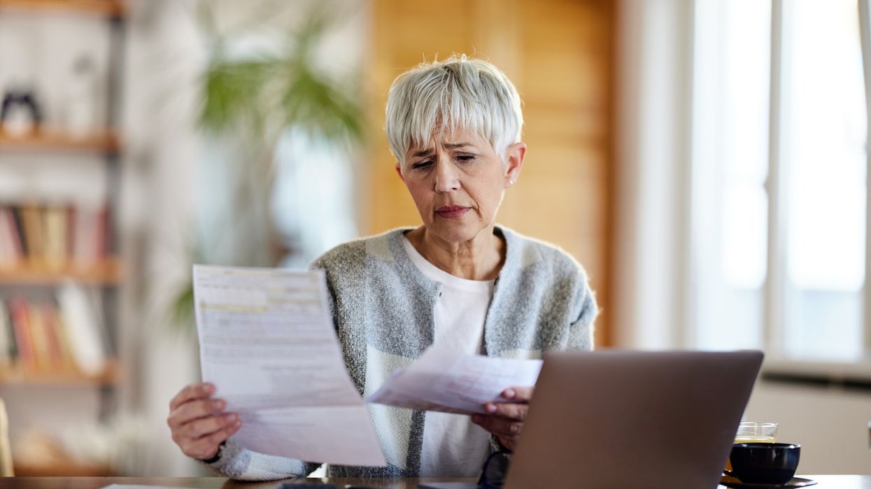 Pensioner worried at laptop