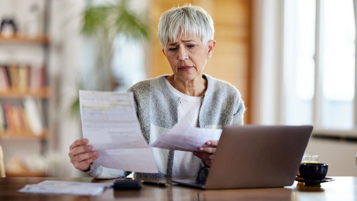 Pensioner worried at laptop
