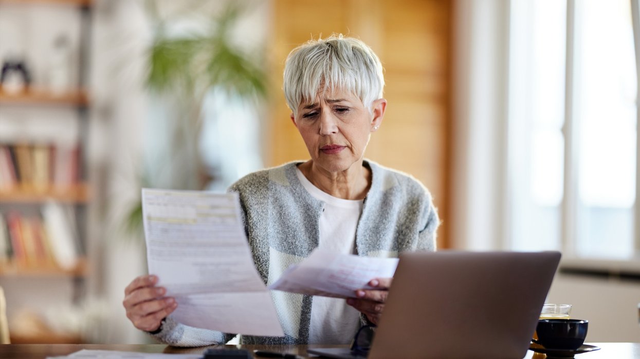 Pensioner worried at laptop