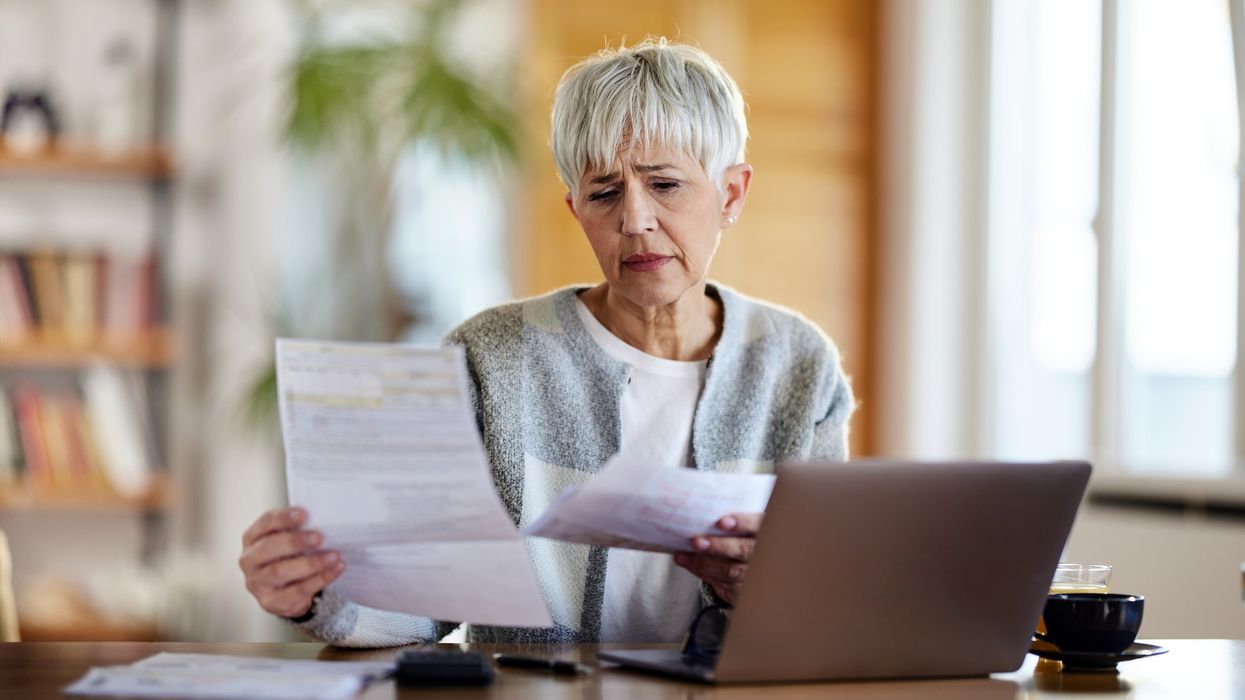 Pensioner worried at laptop