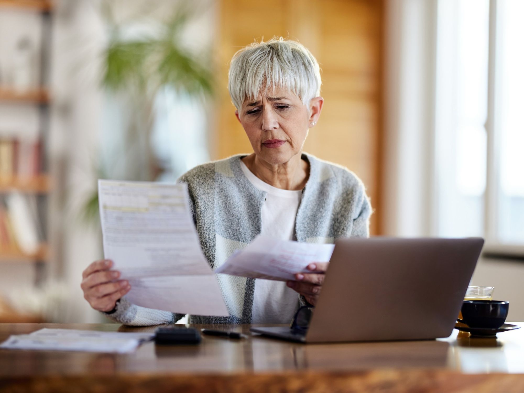 Pensioner worried at laptop