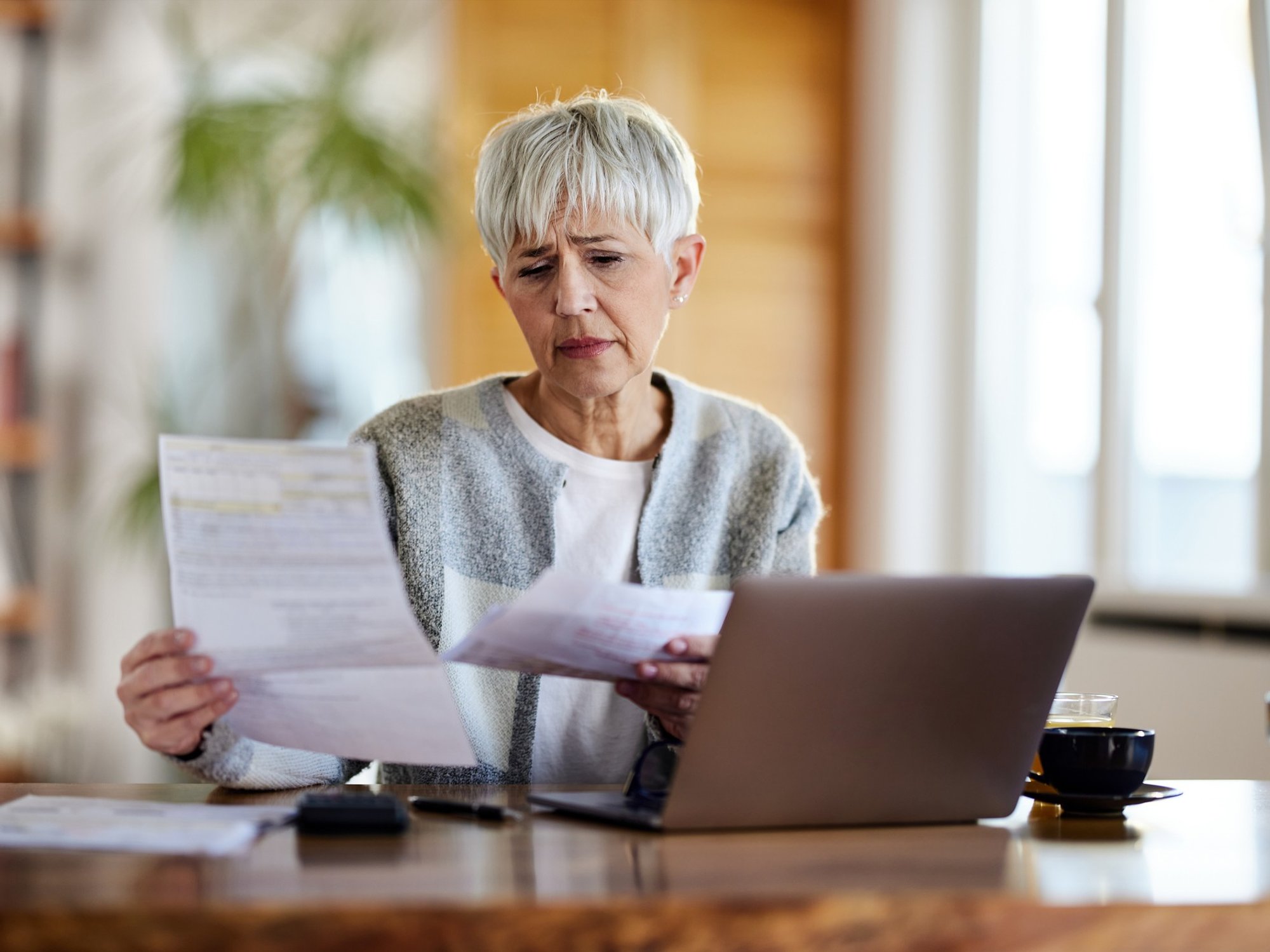 Pensioner worried at laptop