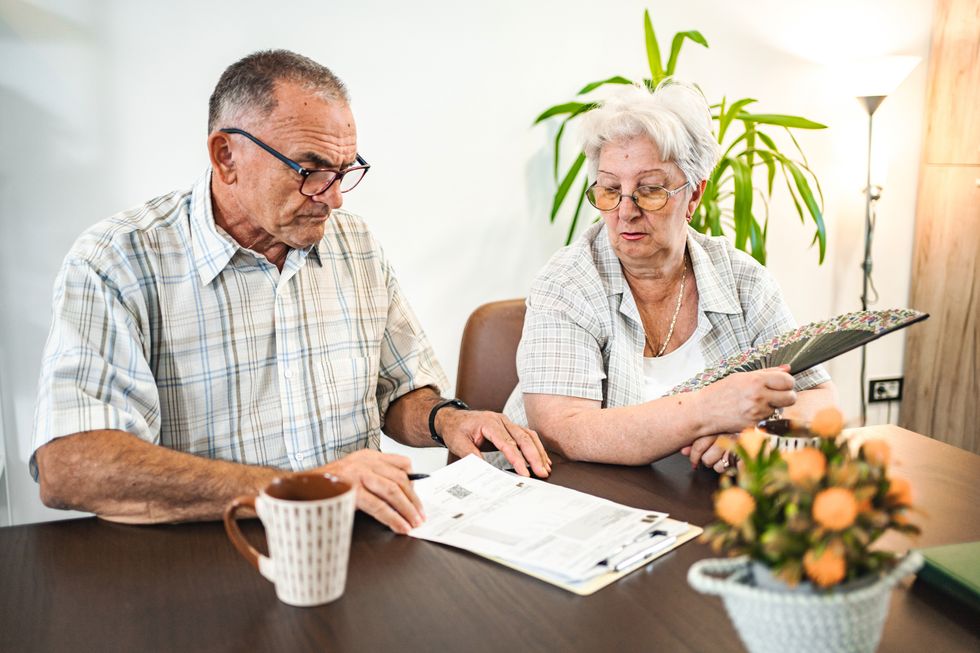 Pensioners look at documents