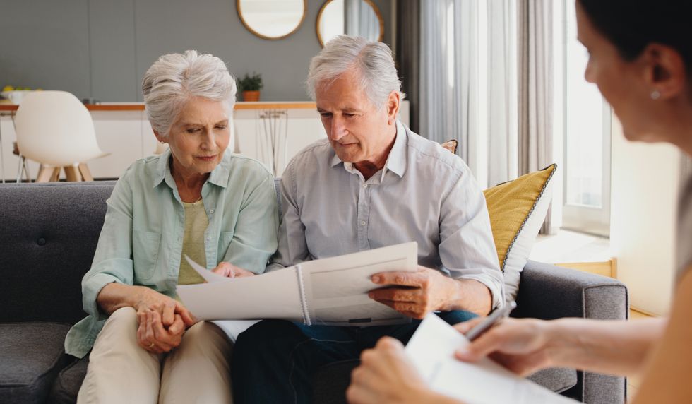 Pensioners look at documents