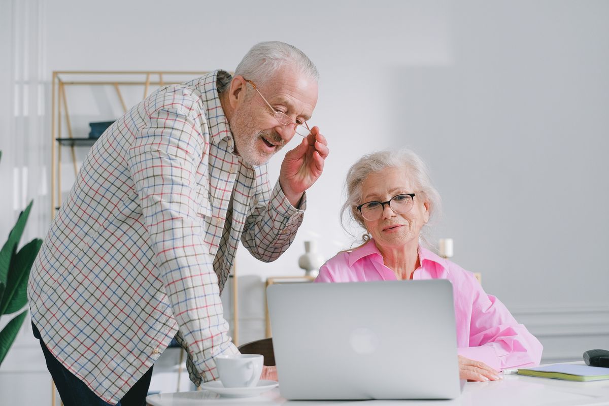 Pensioners look at laptop