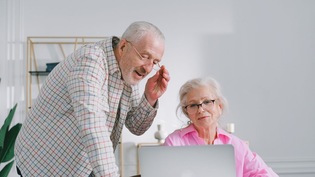 Pensioners look at laptop