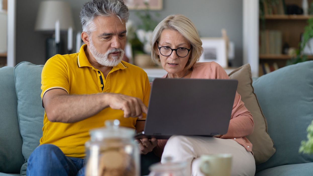 Pensioners look at laptop