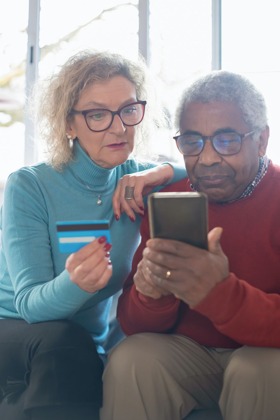 Pensioners look at tablet and phone