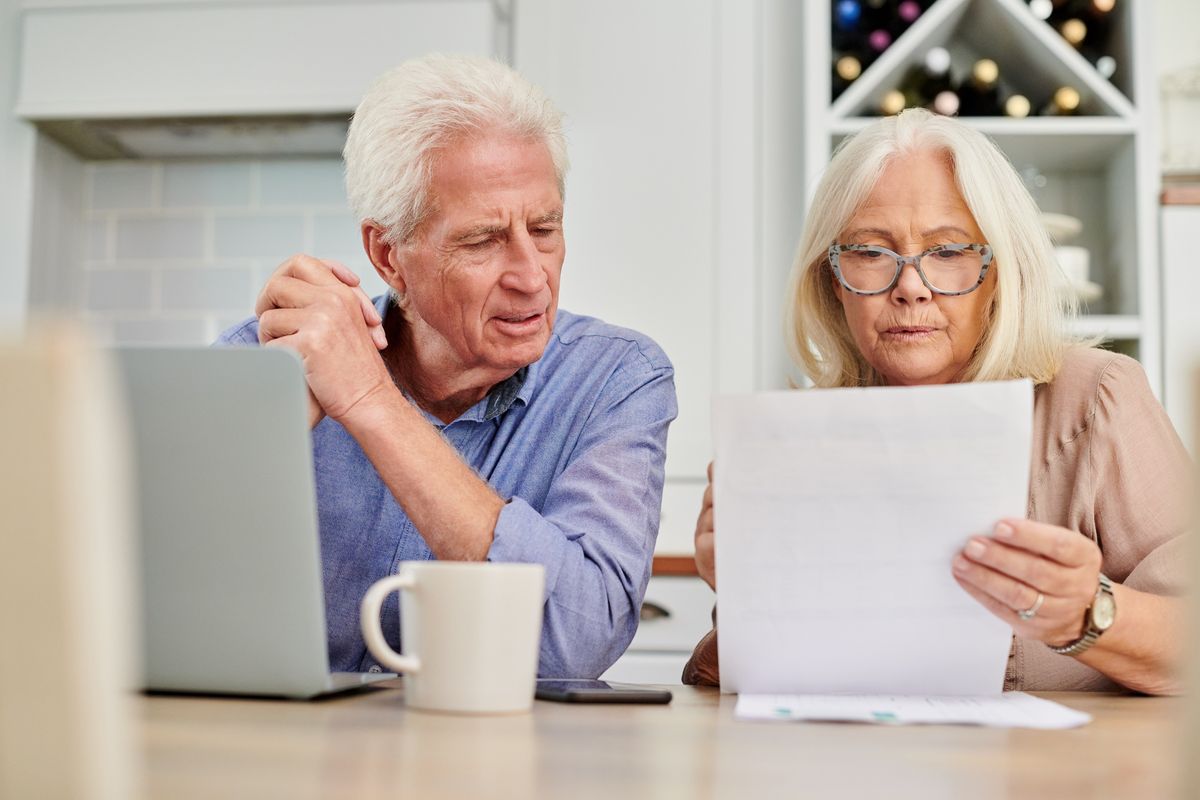 Pensioners look at tax letter in pictures