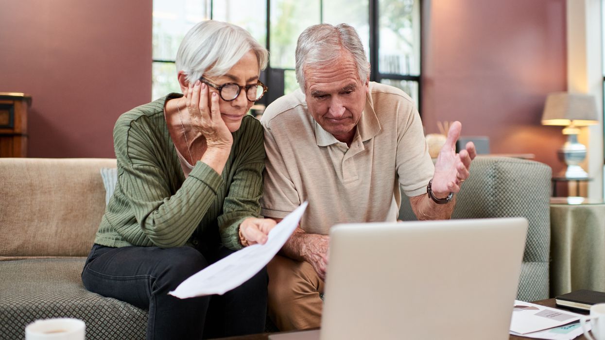 Pensioners look puzzled at laptop