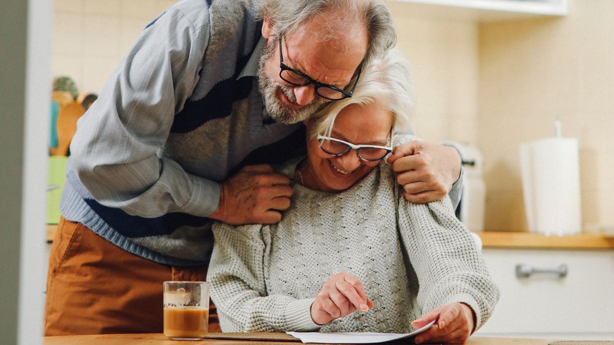 Pensioners looking at document very happily