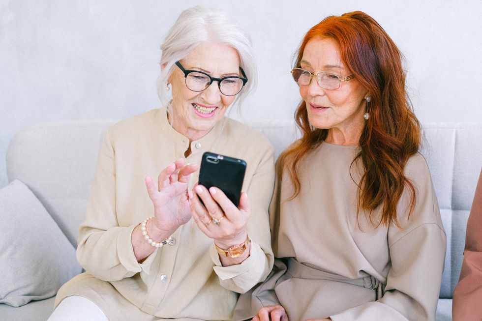Pensioners looking at phone