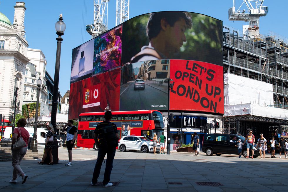 Peope at Piccadilly Circus, London, after the final coronavirus legal restrictions were lifted in England. Picture date: Monday July 19, 2021.