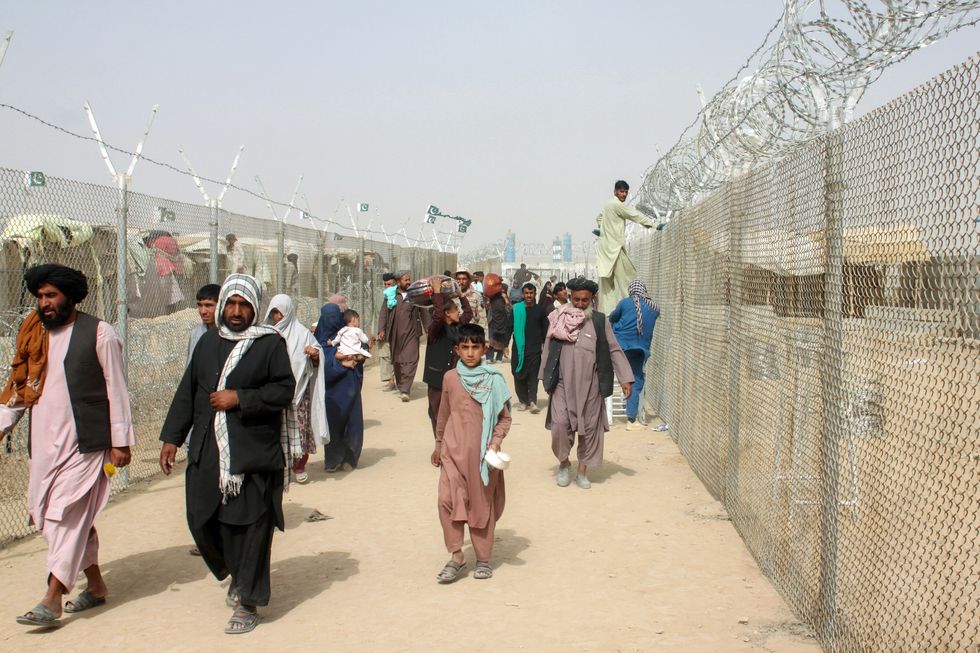 People arriving from Afghanistan make their way at the Friendship Gate crossing point at the Pakistan-Afghanistan border town of Chaman, Pakistan August 16, 2021.