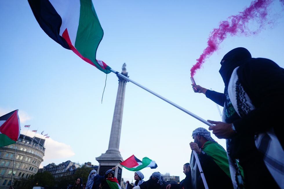 People at a rally in Trafalgar Square, London