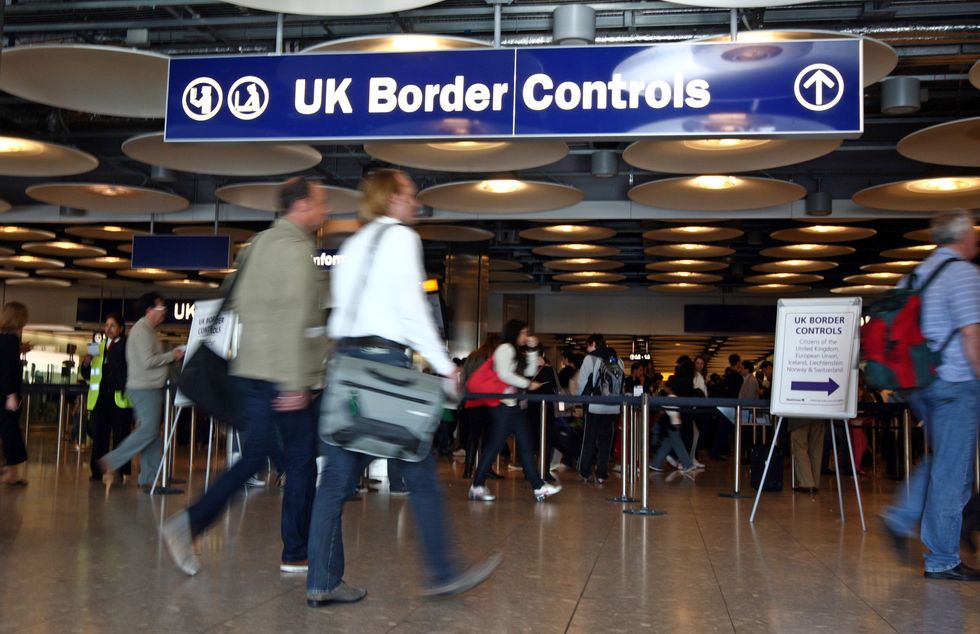 People at Border Control in Terminal Five of London's Heathrow Airport