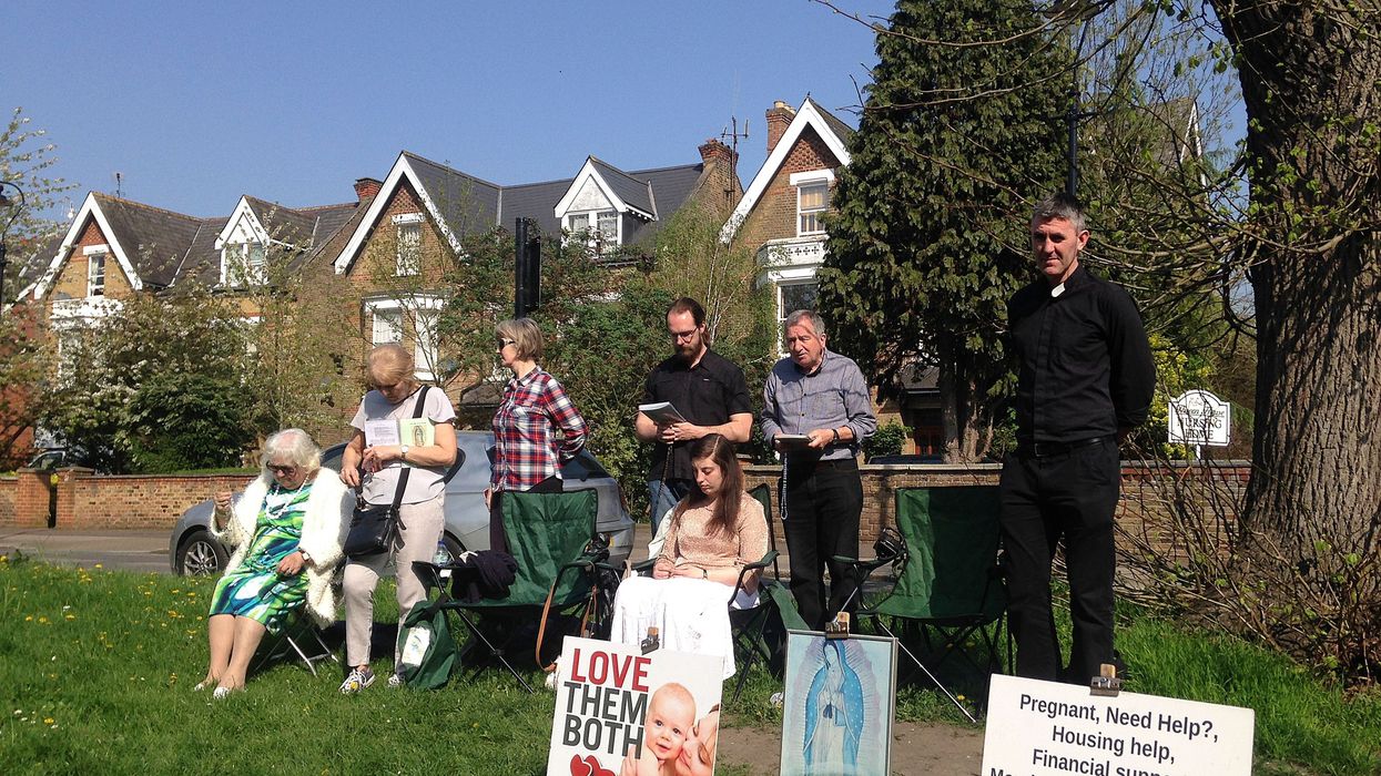 People attend an anti-abortion pro-life vigil on the street