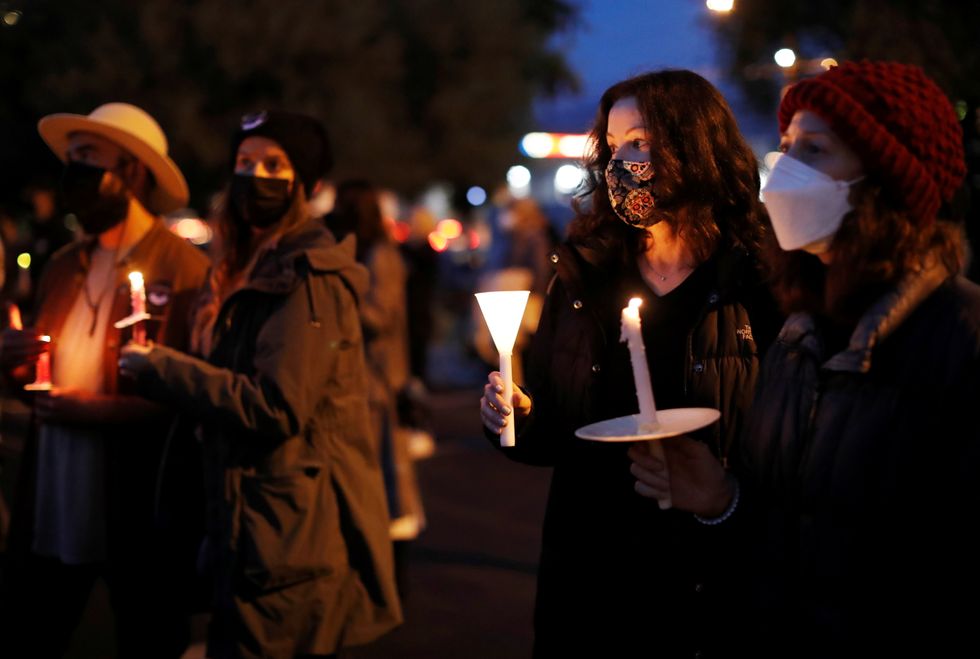 People attend the vigil.