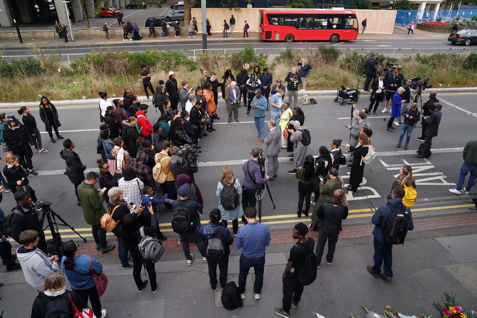 People attending a vigil in Croydon, south London