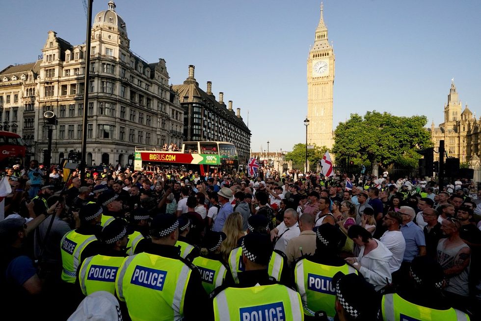 People attending the 'Enough is Enough' protest in Parliament Square, London