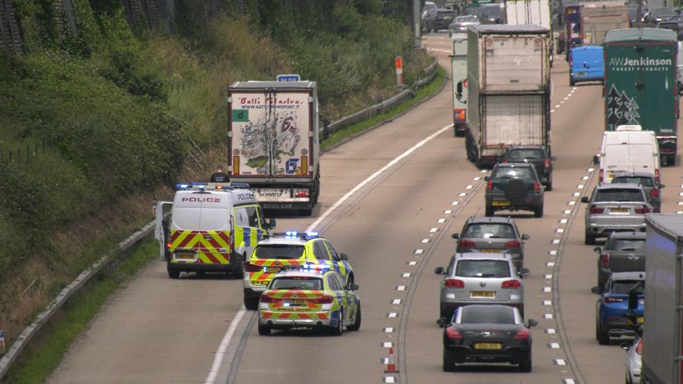 People being searched after having been found in the back of a lorry on the M25 after police received phone calls saying occupants were on board and struggling to breathe. Picture date: Thursday July 1, 2021.